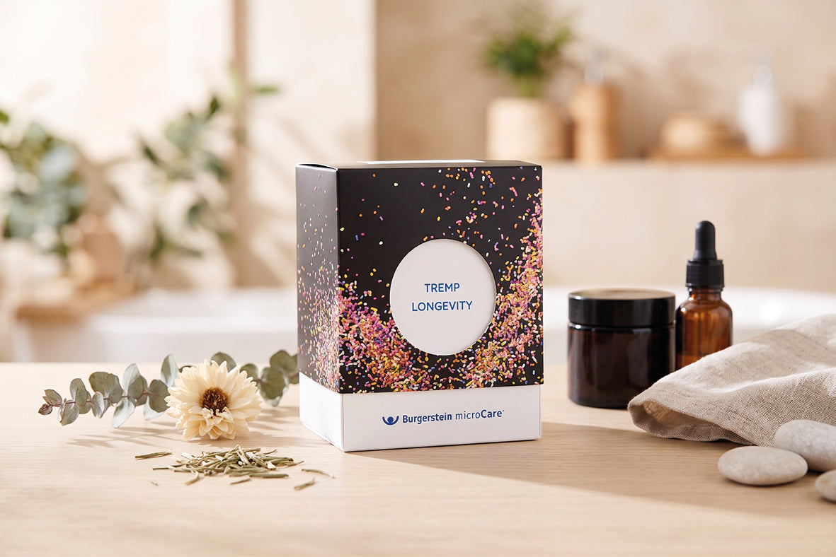 TREMP Longevity von Burgerstein microCare – Verpackung auf Holztisch mit Blüte und Eukalyptus
