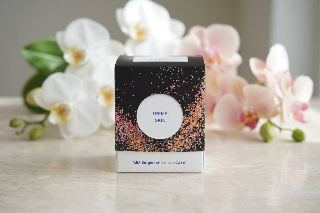 TREMP Skin von Burgerstein microCare – Frontansicht der Verpackung vor Orchideen